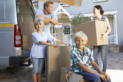 Mover using protective gloves while handling furniture safely