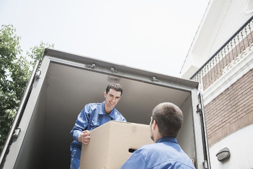 House movers carrying boxes from a Hampstead flat