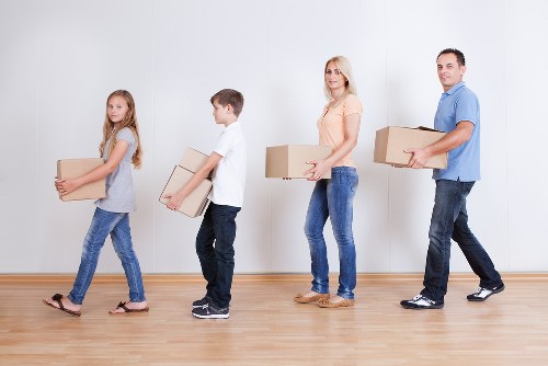 Local movers handling furniture and boxes in a Hampstead property